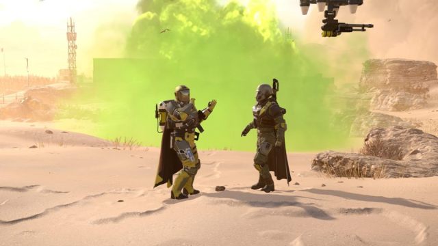 Two Helldivers executing a pull my finger victory pose with a toxic gas explosion behind them and a drone in the air