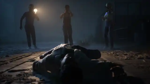 Three teenagers film a dead body on the ground