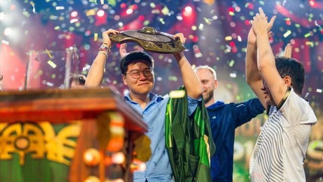 Blitz, coach for  Team Liquid, lifts Dota 2's Aegis of Champions as confetti falls around him at TI 2024.