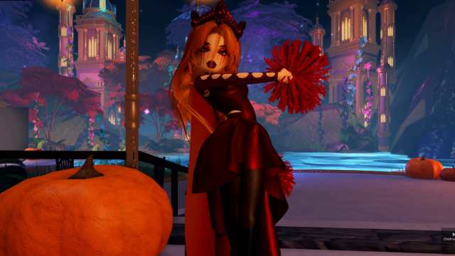 A player dressed as Scarlet Witch with a slinky red outfit, orange hair, a dark red crown, and red pom poms in Dress to Impress.