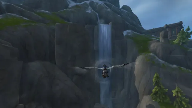 Flying towards waterfall cave in World of Warcraft.