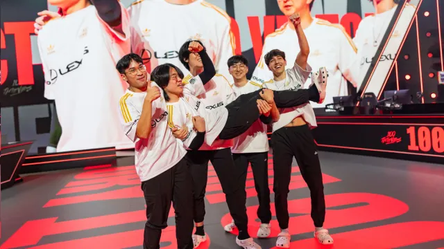 100 Thieves celebrate on stage at the LCS Summer Championship after a win against Cloud9.