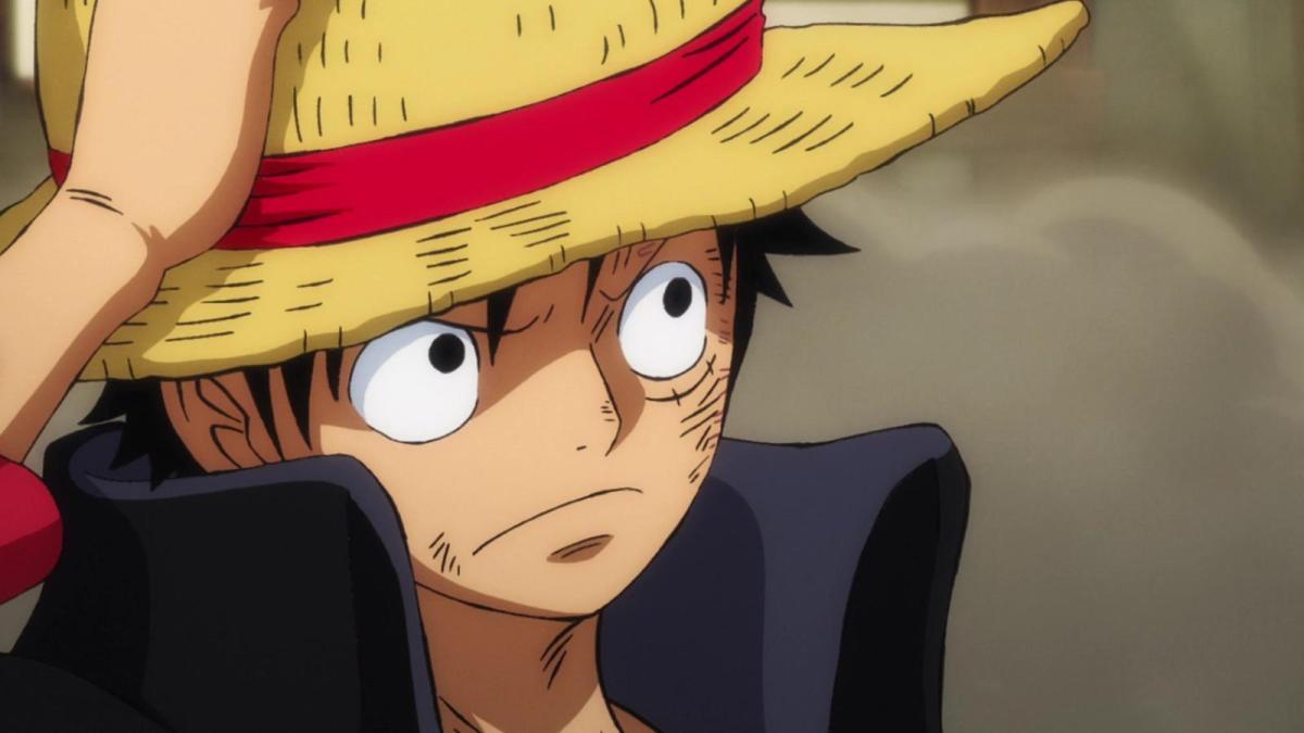 Luffy from One Piece holds his straw hat with his hand as he looks through gathering smoke