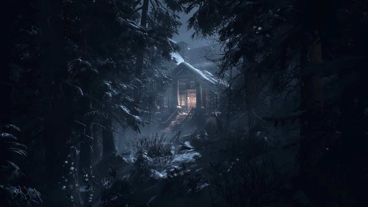 A creepy house covered in snow sits beyond trees