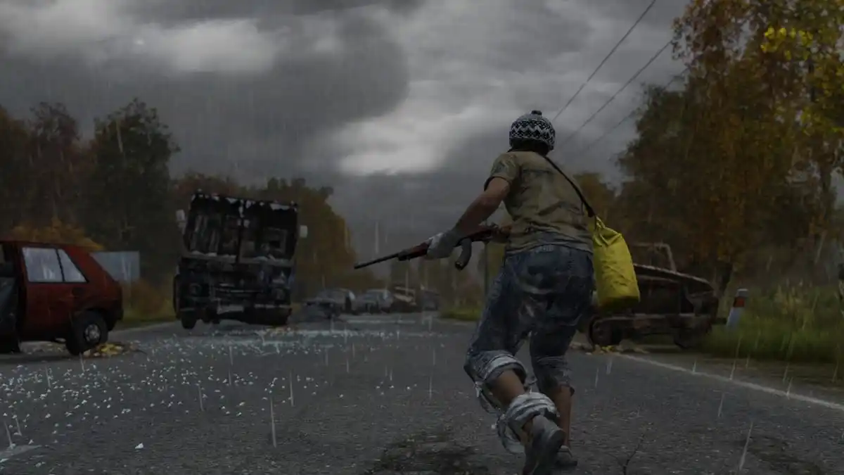 Player character running through an abandoned road, gun in hand with ruined vehicles in the background