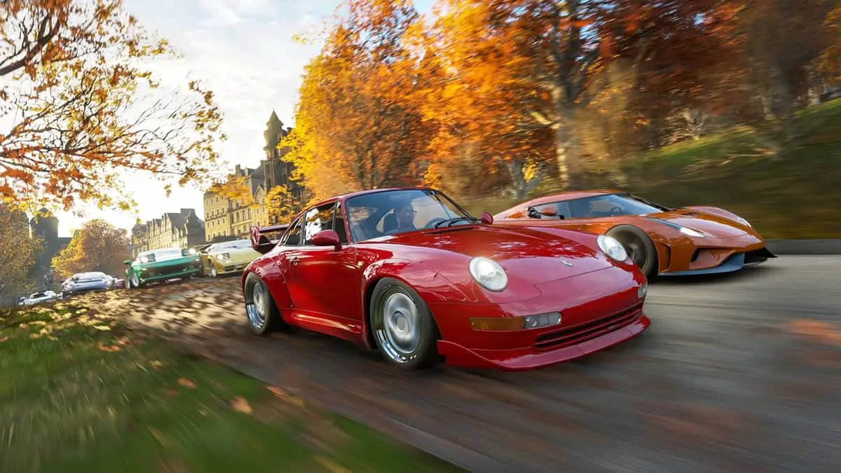 Six cars racing through a forested path with a mansion in the background