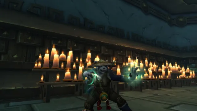 Pandaren Monk casting a spell in a temple covered in candles in World of Warcraft.