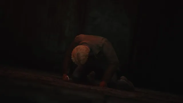 James on his knees with his hands on the ground and his head pointing down in Pyramid Head boss fight