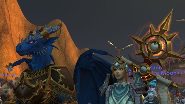 Dracthyr and human mage watching the stage in World of Warcraft.