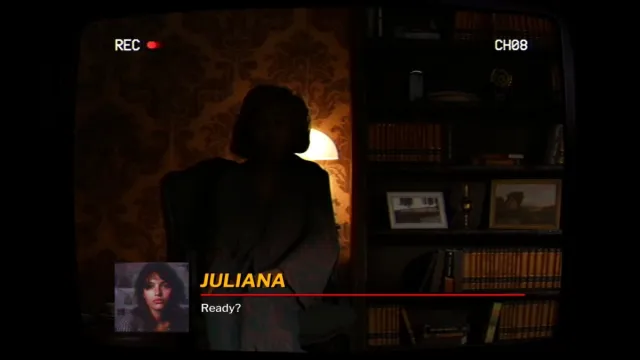 Juliana asking the widow if she's ready for the interview with the widow shown sitting down next to bookcase