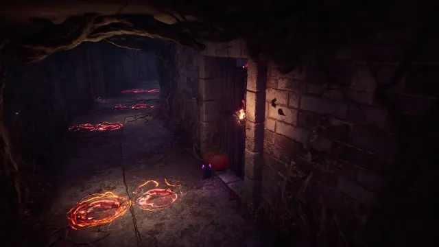 A small group of pumpkins hide in a stone archway that leads out of a dark corridor with glowing red spots on the ground. Image from the Haunted Labyrinth event dungeon from Throne and Liberty.