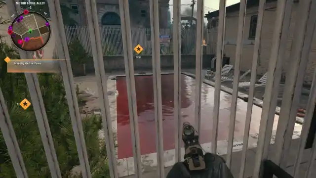 A player in Black Ops 6 Zombies looking through a fence at a pool filled with blood.