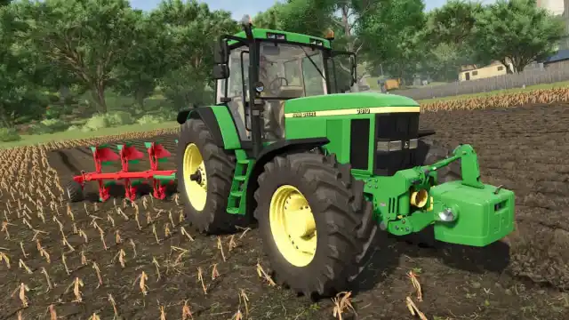 John Deere 7810 standing on a field in Farming Simulator 25.