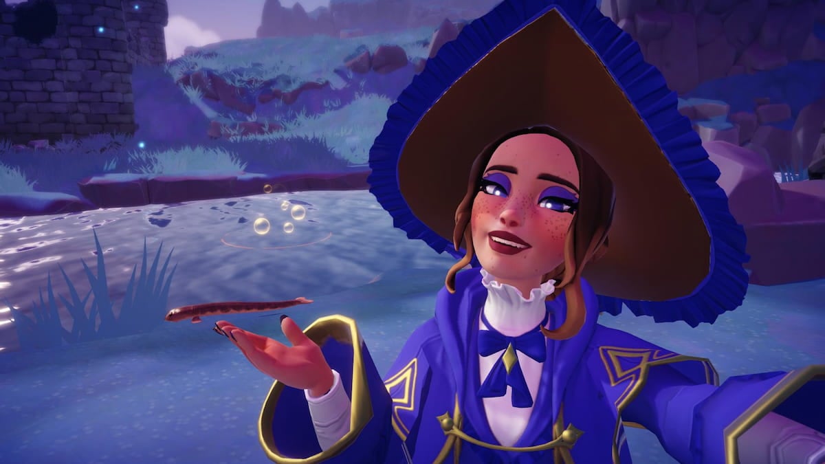 A player with a big purple witch hat smiling and holding out their hand to highlight a long brown Lamprey fish on the ground by the water in Disney Dreamlight Valley.