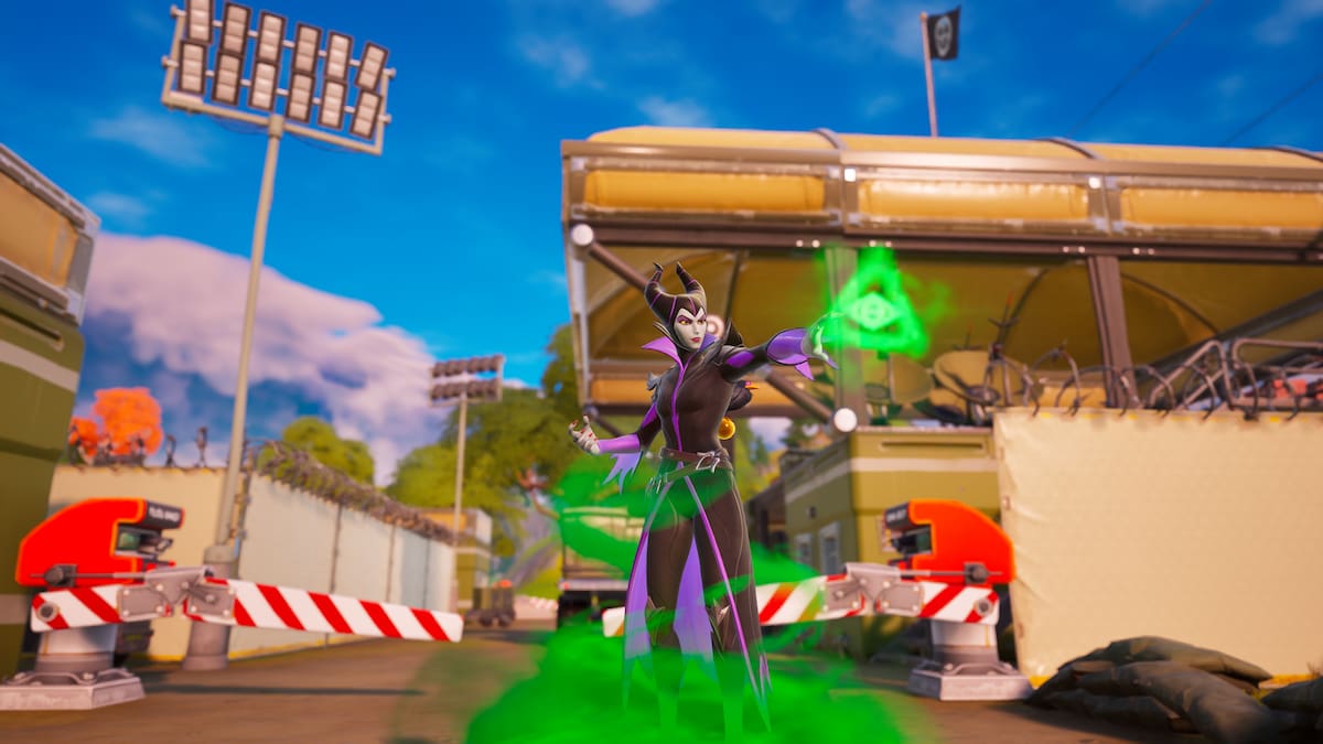 Maleficent using green magic in front of a military camp in Fortnite.