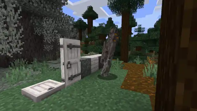 Several Pale Oak type of blocks, a pale door, and a pale trapdoor in Minecraft.