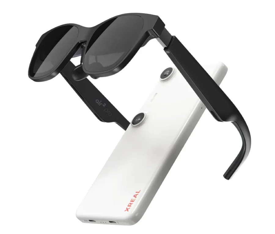 3/4 back view of the XREAL BEAM Pro and XREAL Air 2 Pros. The Air 2 Pros are an all-black plastic VR set about the size and shape of eyeglasses. The BEAM Pro is a white brick roughly the size and shape of a smartphone. More details below.