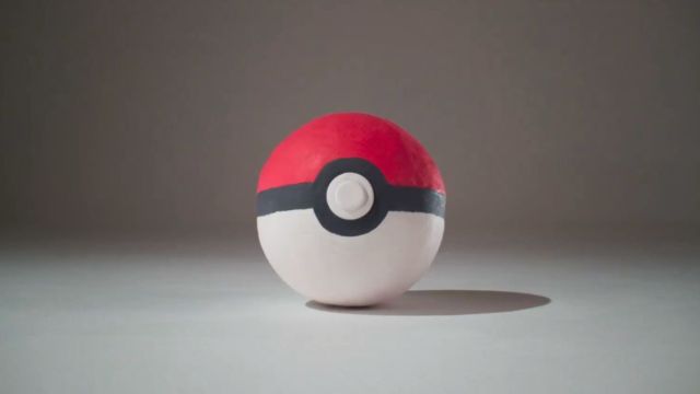 Clay Pokeball from upcoming Pokemon and Aardman Animations collaborative project with grey background.