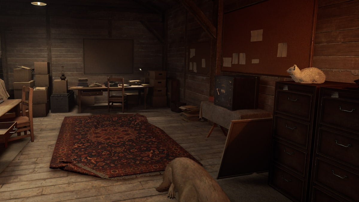 An empty cabin room with a carpet, desk, safe, couch, as well as a dog lying on the floor and a cat lying on a shelf.