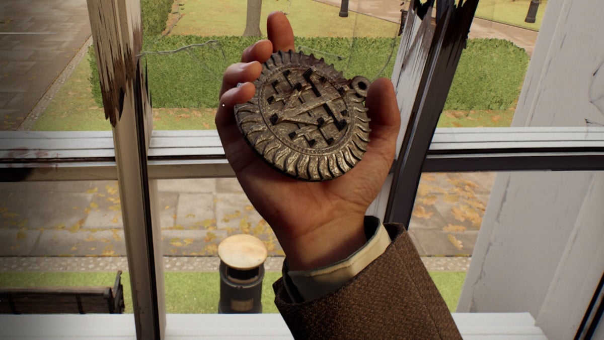 indiana jones holding a golden pendant