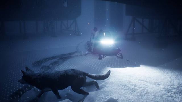 A shot of a researcher on a snowmobile with a dog running past ahead of it