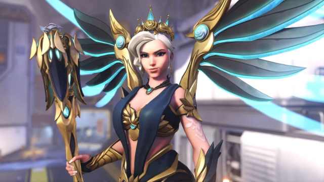 An image of the new Rose Majesty Mercy skin in Overwatch 2, which decorates her in a dark blue dress and gold accents.