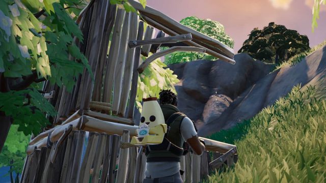 A wooden building in front of a Fortnite player.