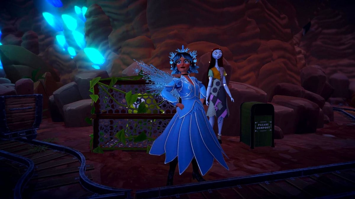 A player wearing an icy blue fairy outfit with wings standing with their hands on their hips with Mike in a trap on one side and Sally standing on their other in Disney Dreamlight Valley.