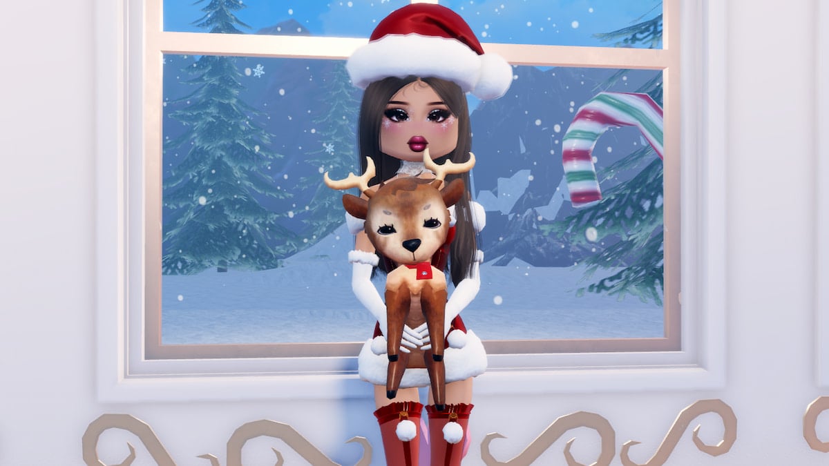 A player wearing a red santa hat holding a small brown reindeer in Dress to Impress.