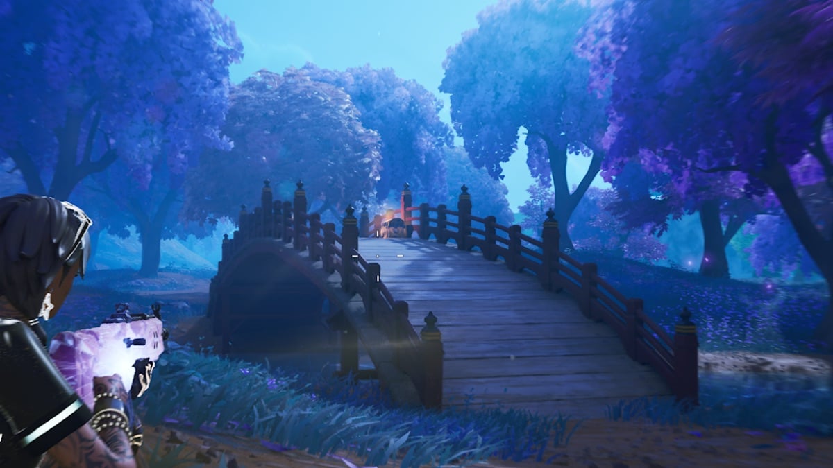 fortnite character slides towards a chest on a bridge in a forest at night