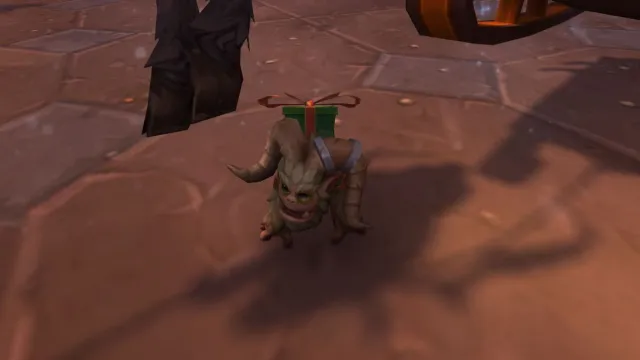 Grunch Battle Pet yeti with a present on its back in World of Warcraft.