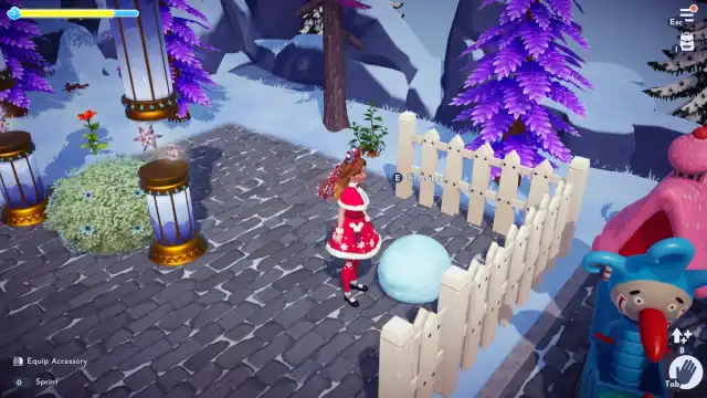 A player dressed in a festive red winter outfit standing next to a  big white snowball base in Disney Dreamlight Valley.