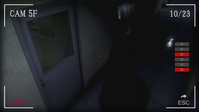 A tall, dark figure looking at a door on the camera monitors