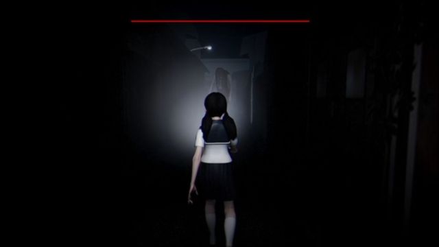 Third-person shot of the protagonist shining a light in front of her at the evil spirit