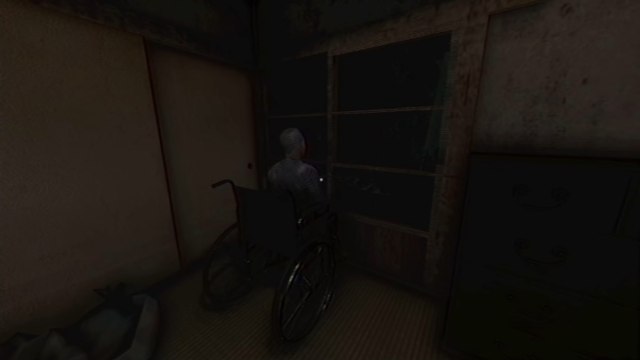 Souchi sitting in the wheelchair, looking out into darkness from the window