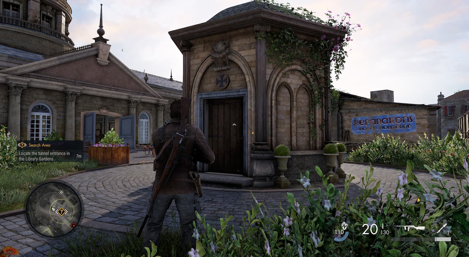 The main character from Sniper Elite Resistance standing in front of a six-sided building. It has a wooden door and a cross symbol above it.