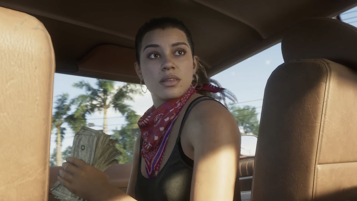 Grand Theft Auto 6 Lucia holding a stack of cash looking back from the passenger seat