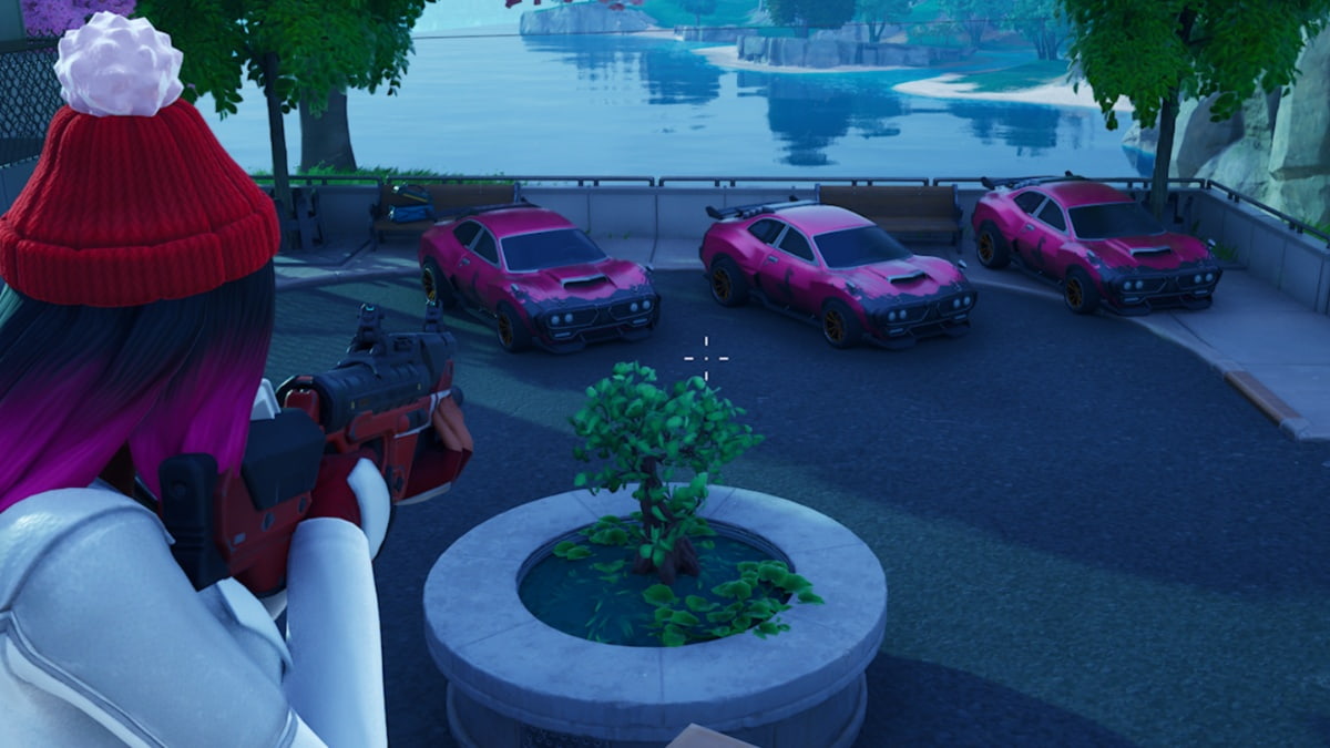 fortnite character in red wool hat pointing a gun at three identical pink cars