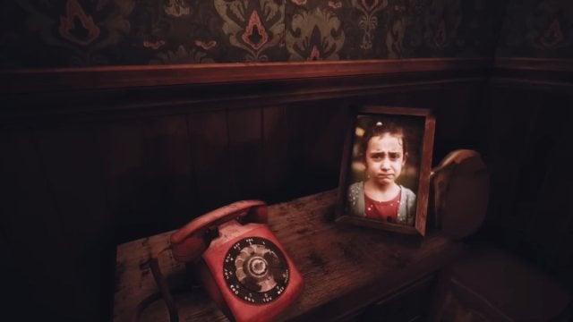 A shot of a cabinet in CatNap's nightmare section with a rotary phone and a portrait of a young girl next to it