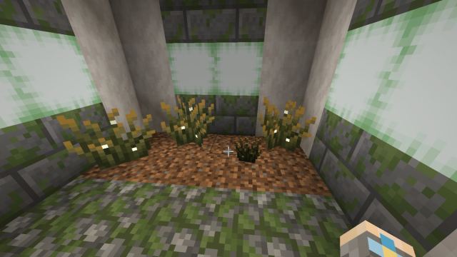 Three planted firefly bushes and one broken one floating on some dirt in Minecraft.