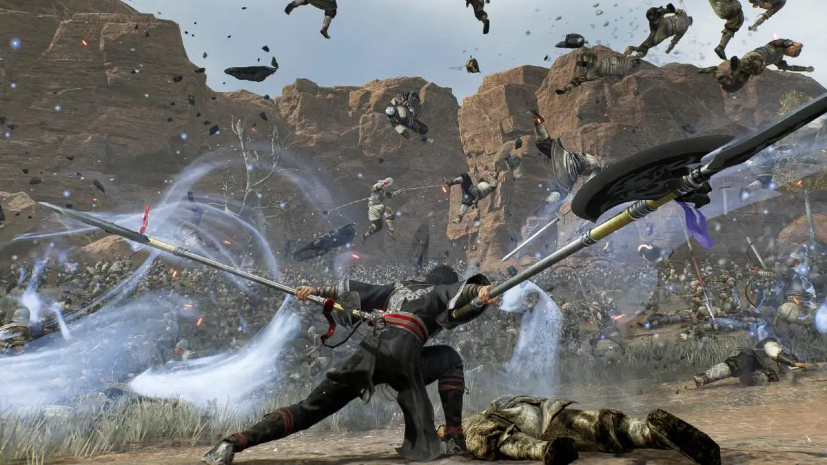 Main character posing with twin pikes with enemies flying around them after devastating attack in Dynasty Warriors Origins