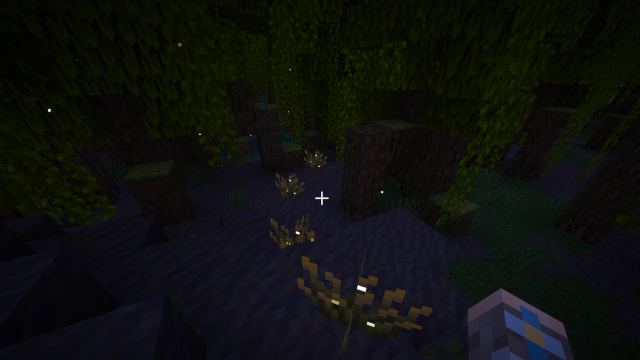 Four firefly bushes in a mangrove swamp in Minecraft.