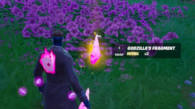 Gambit looking at Godzilla's Fragment on the ground in Fortnite.