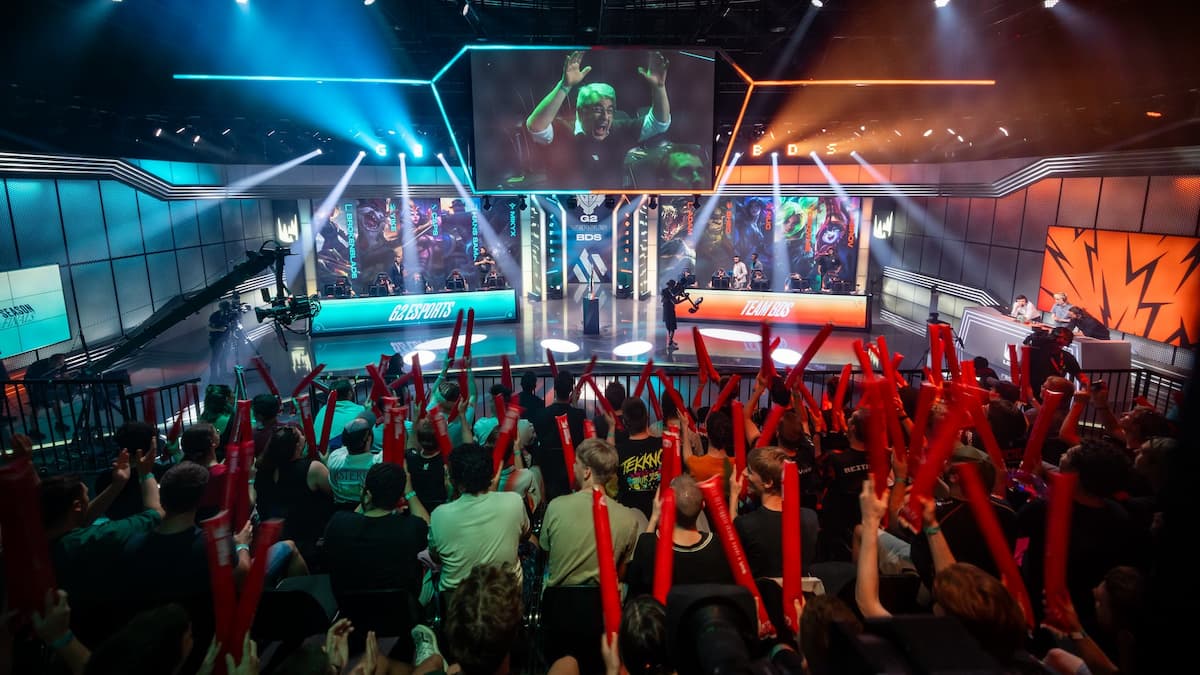 A crowd cheers at the LEC Championship as two League of Legends teams go head-to-head on stage.