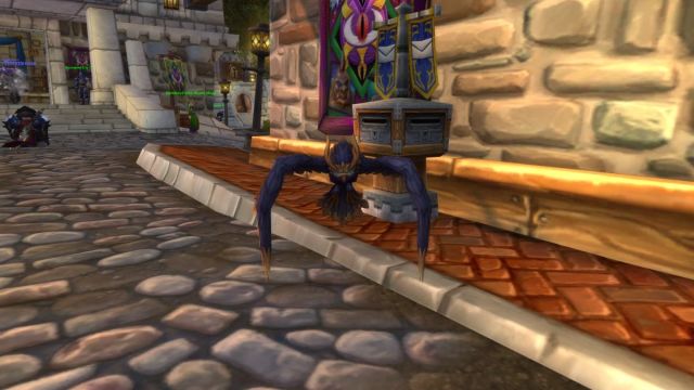 Owl pet in World of Warcraft outside a post box.