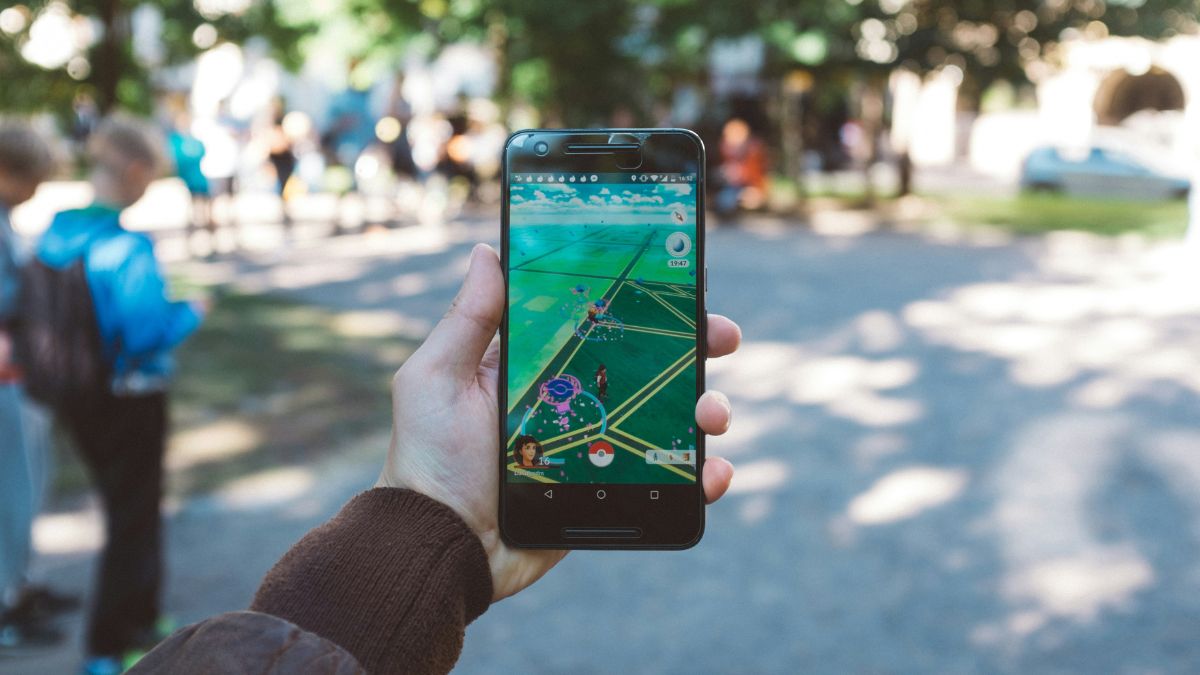 Hand holding Pokemon Go phone during an in person event.