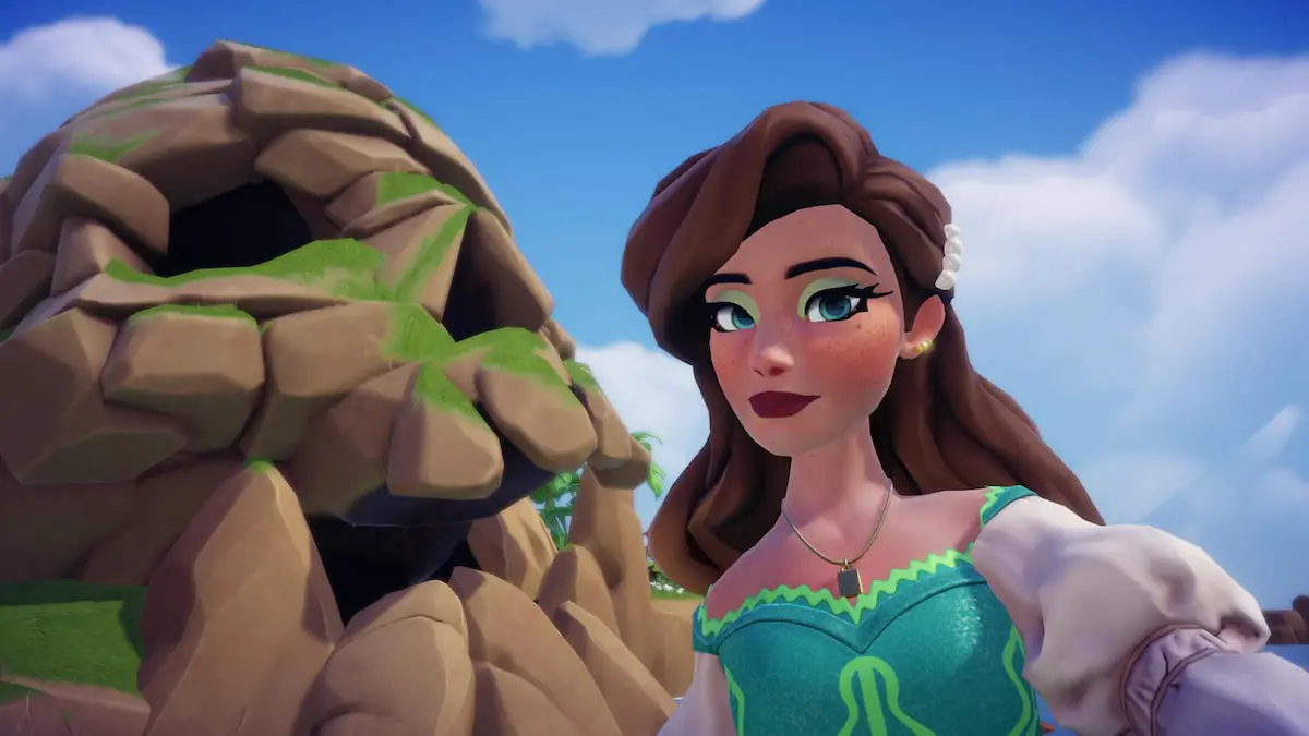 A player with brown hair and a turquoise dress taking a picture with Skull Rock in Disney Dreamlight Valley.