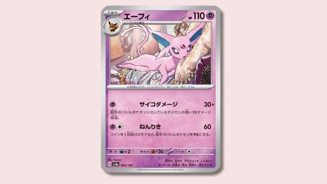 Espeon Pokémon card on a pink background.