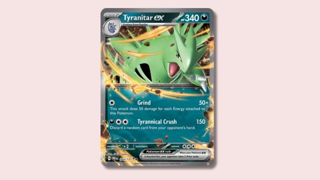 Tyranitar ex Pokémon card on a plain pink background.