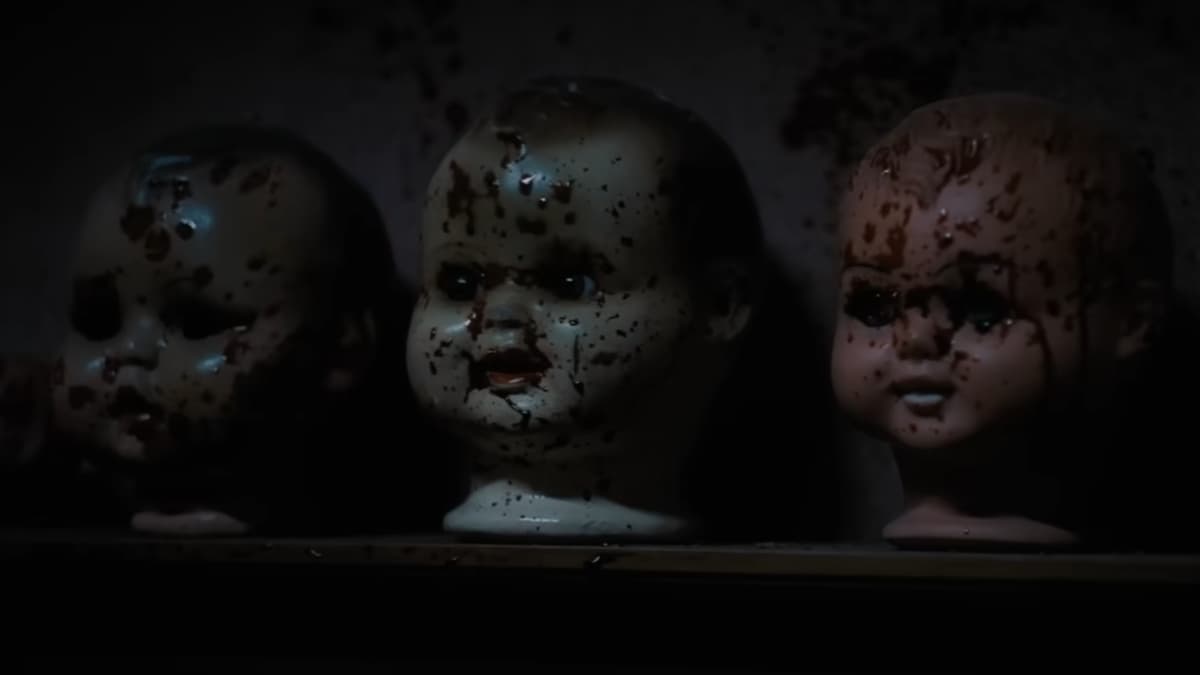 A bunch of doll heads covered in blood.